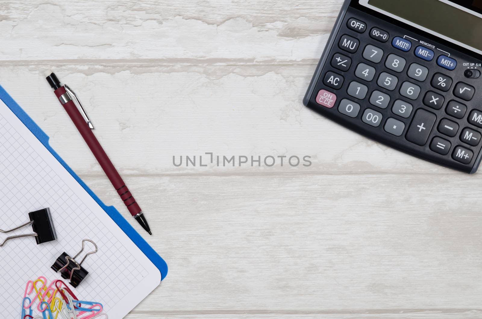 Business desk in office top view. Table with calculator, notepad, and office supplies. Copy space website banner concept