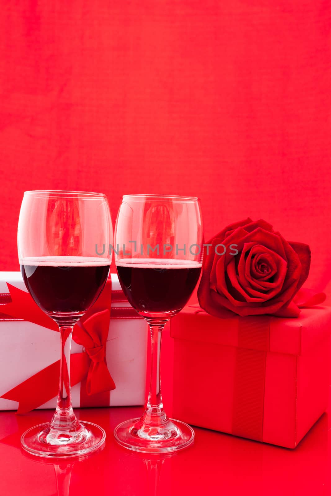 St Valentine's setting with present and red wine by nopparats