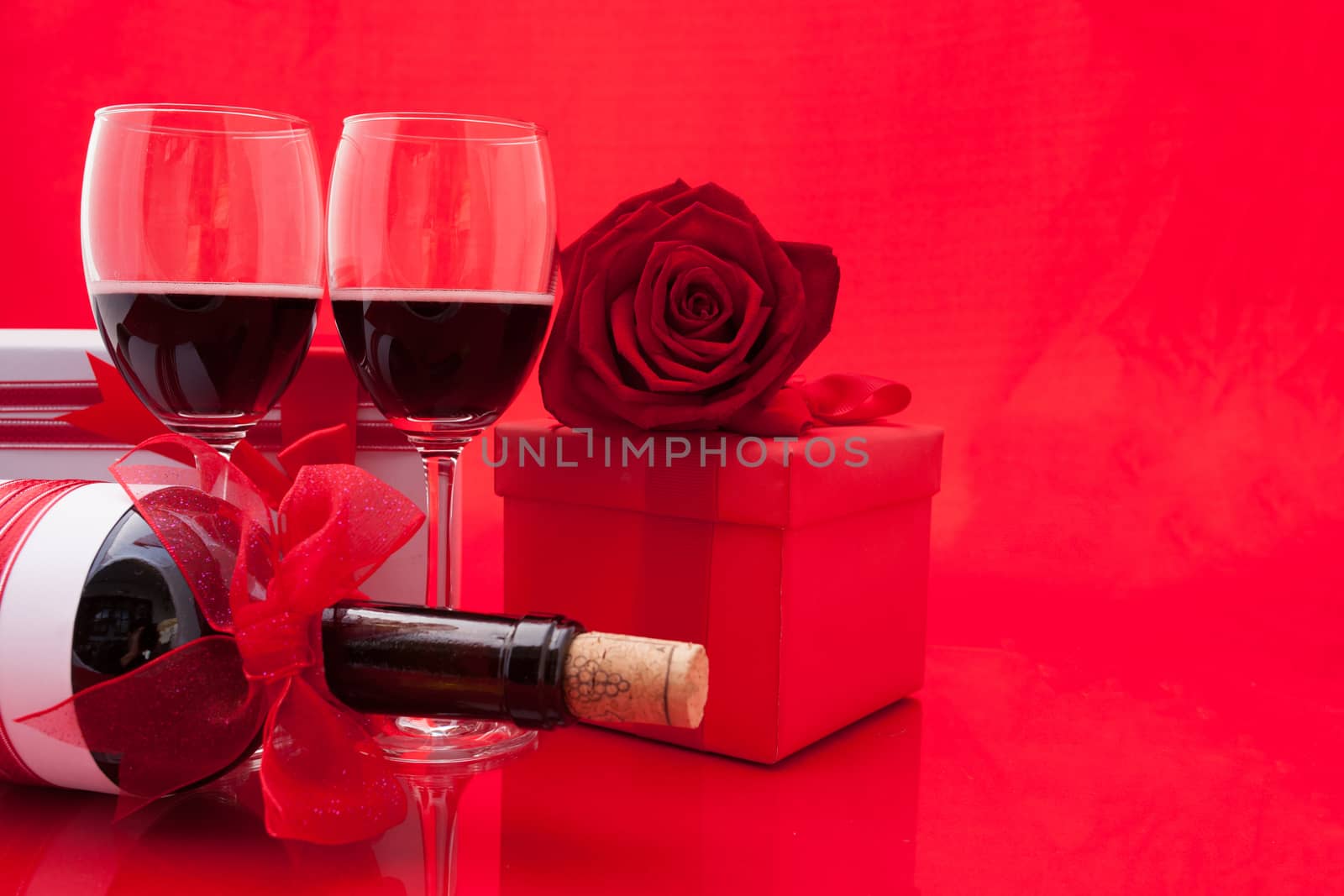 St Valentine's setting with present and red wine.