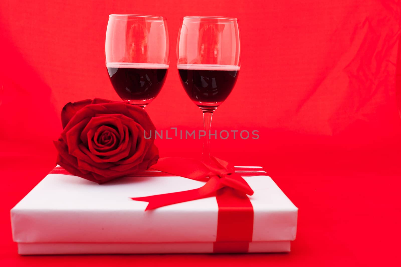 St Valentine's setting with present and red wine by nopparats