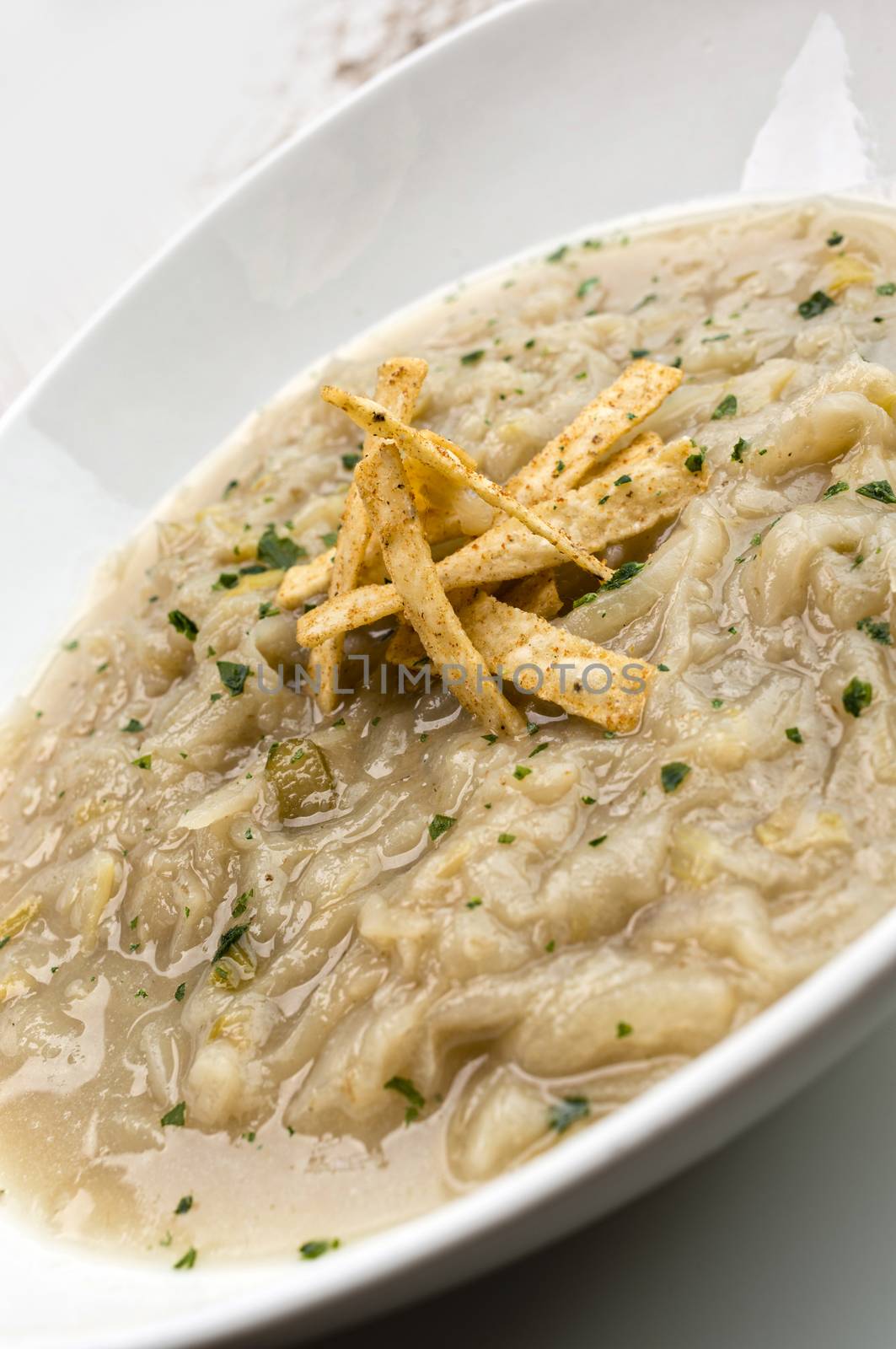 French onion soup with croutons in a white oval modern dish