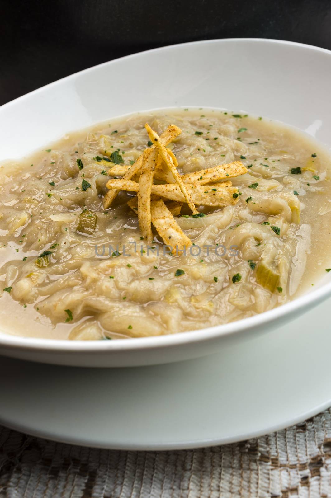 French onion soup with croutons in a white oval modern dish