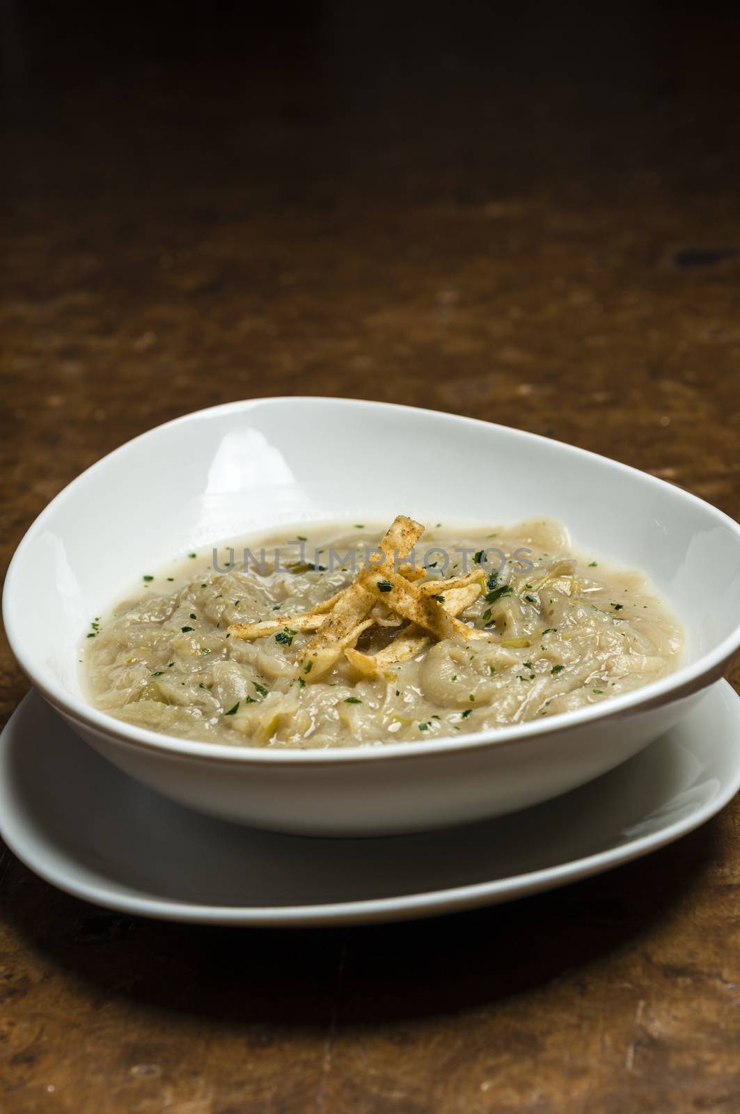 French onion soup with croutons in a white oval modern dish