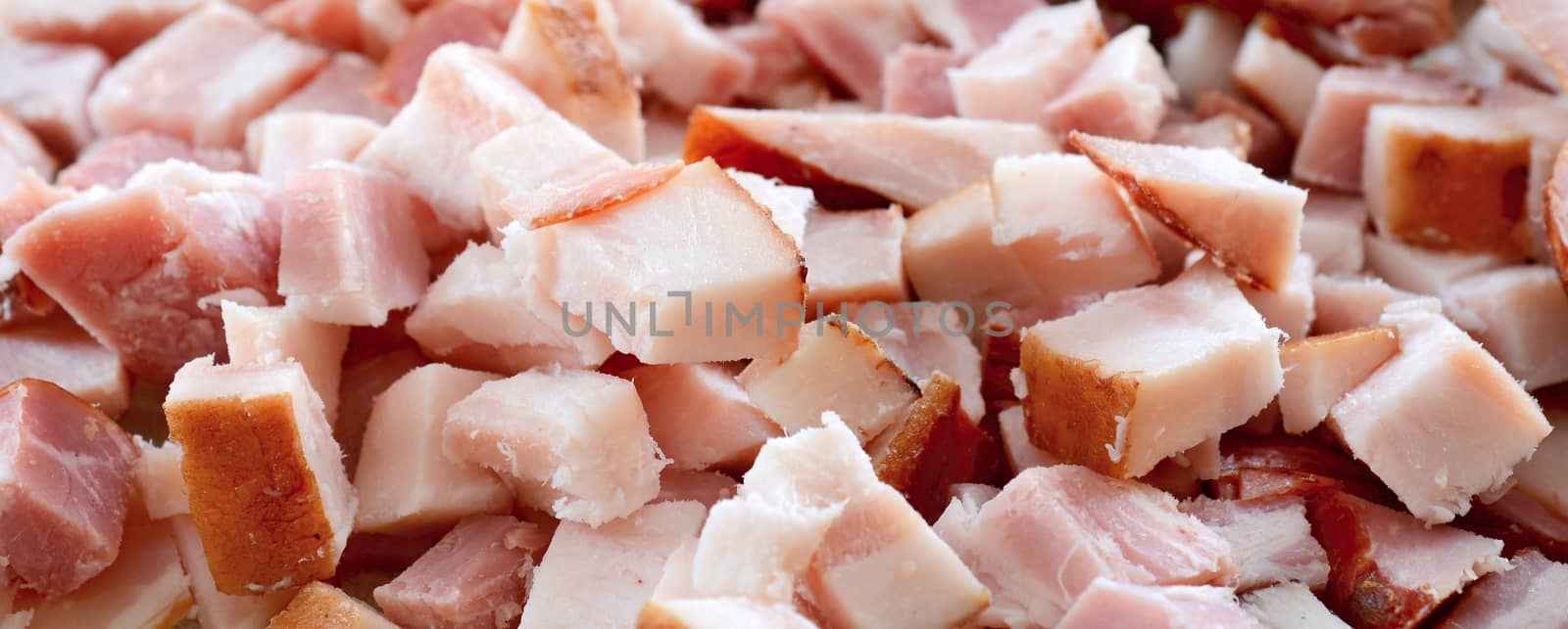 Closeup background with chopped bacon cubes.