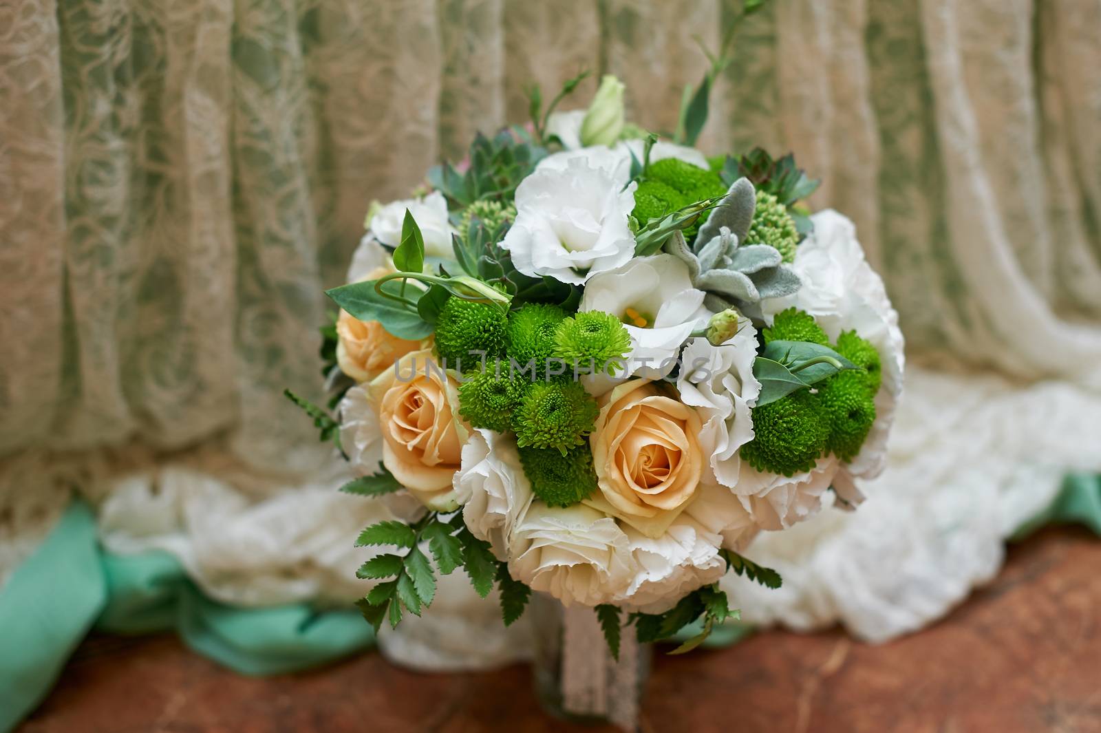 beautiful bridal bouquet on background of curtains in wedding day.