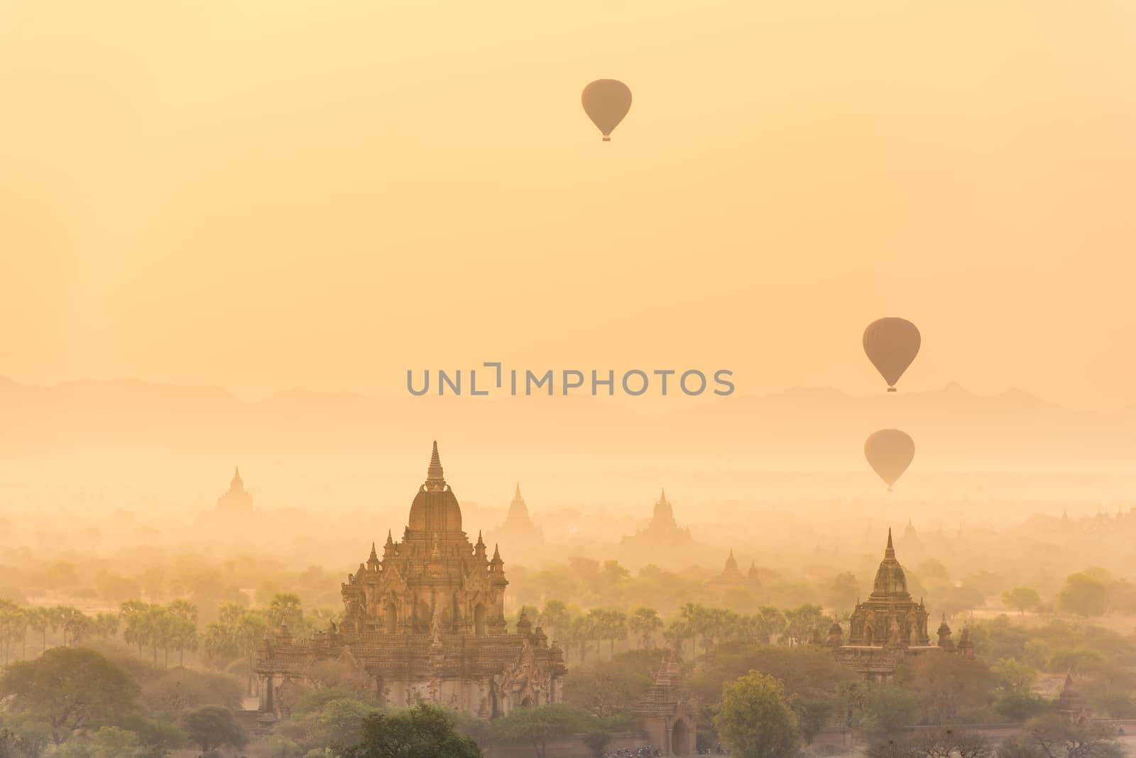 Hot air balloon over plain of Bagan in misty morning before sunrise, Myanmar