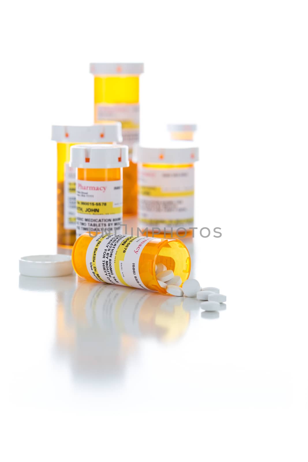 Non-Proprietary Medicine Prescription Bottles and Spilled Pills Isolated on a White Background.