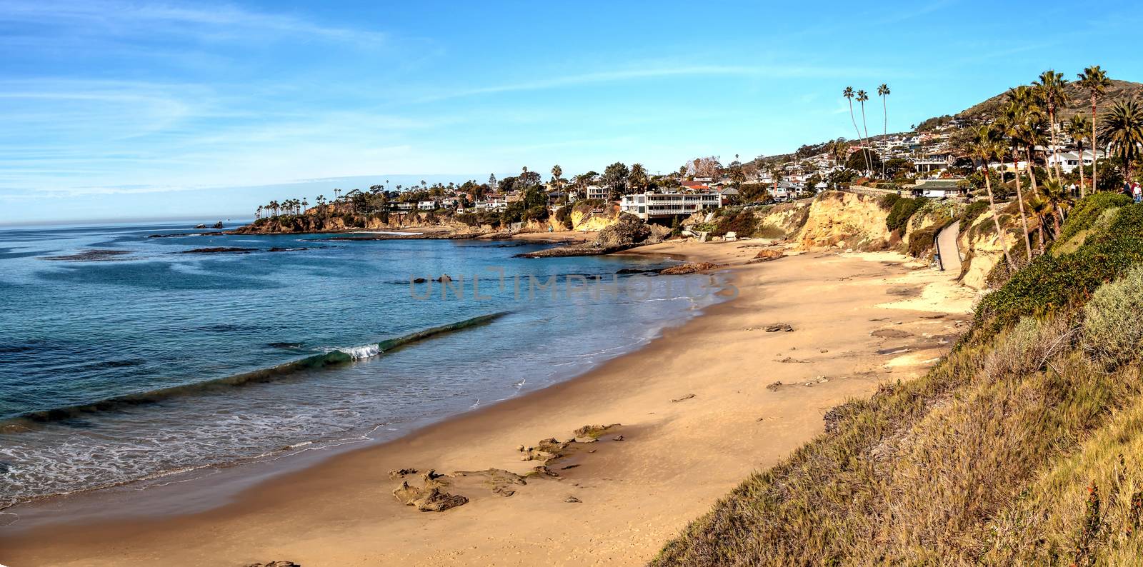 Blue sky over Diver’s Cove Beach by steffstarr