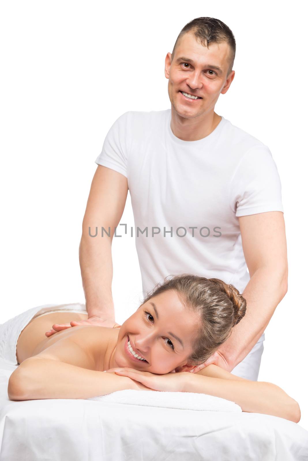 Happy massage therapist and the patient, on a massage table