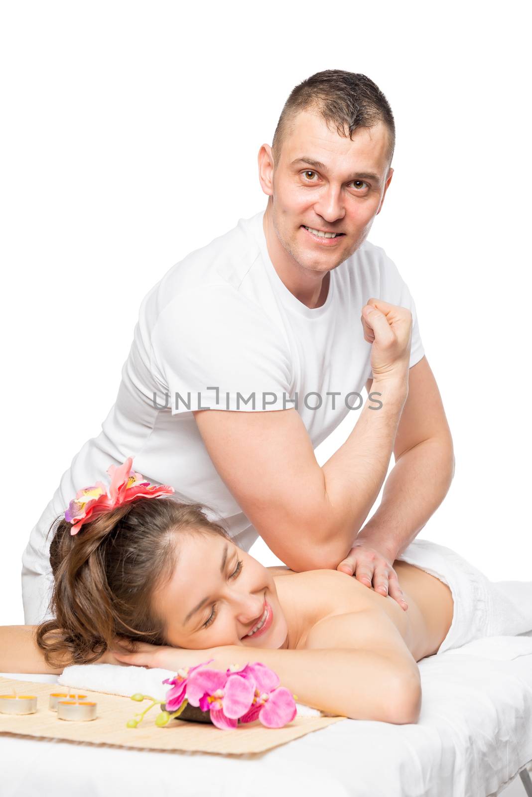 Vertical portrait of a massage therapist at the spa cabinet and happy girl