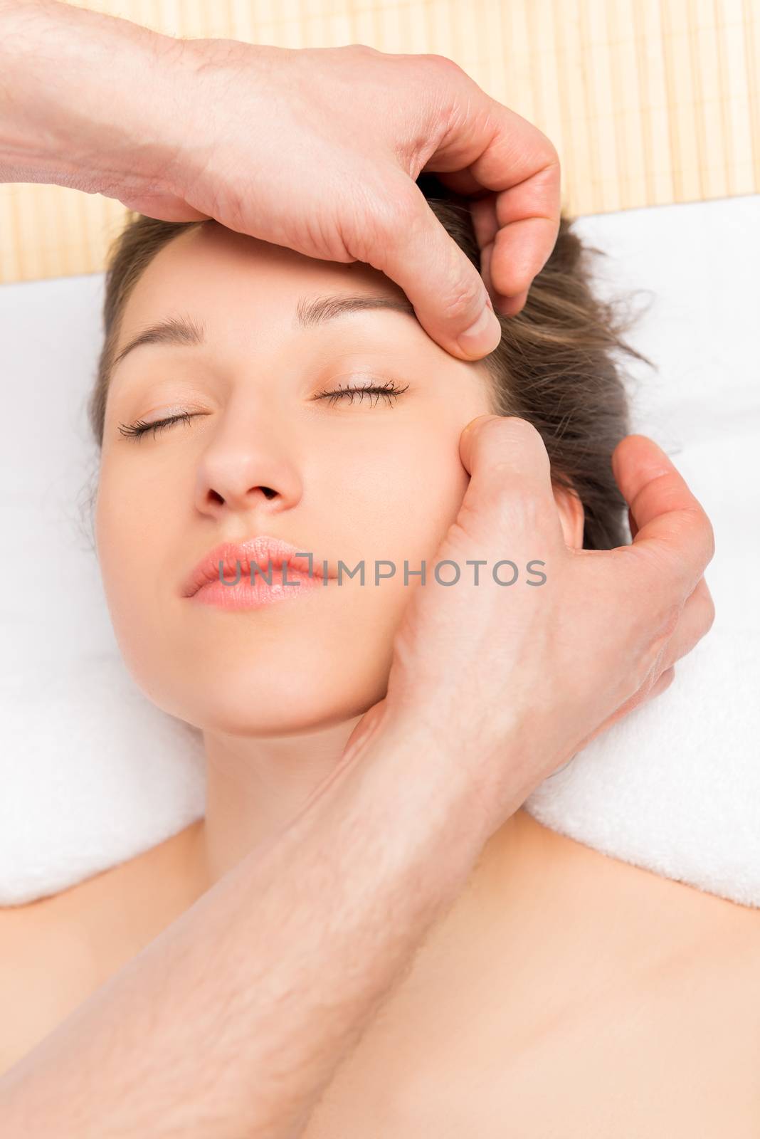 beautician does massage to the girl's face