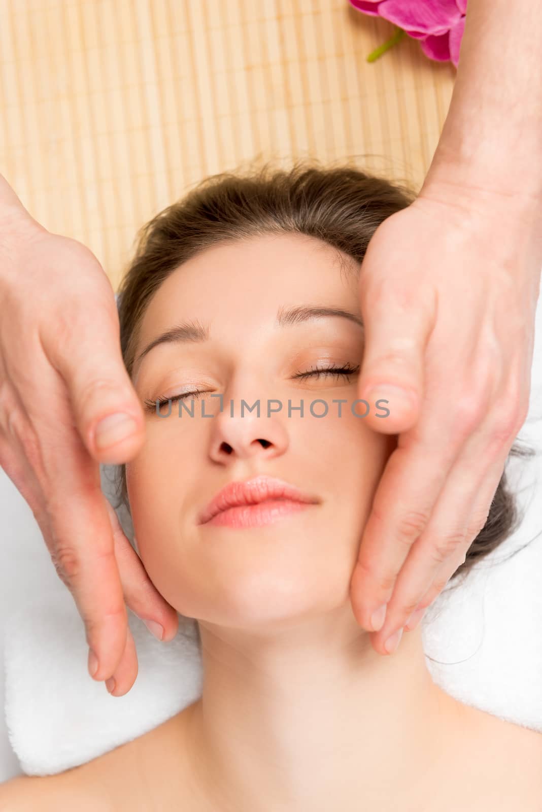 man's hands and woman's face, a face massage in office beautician
