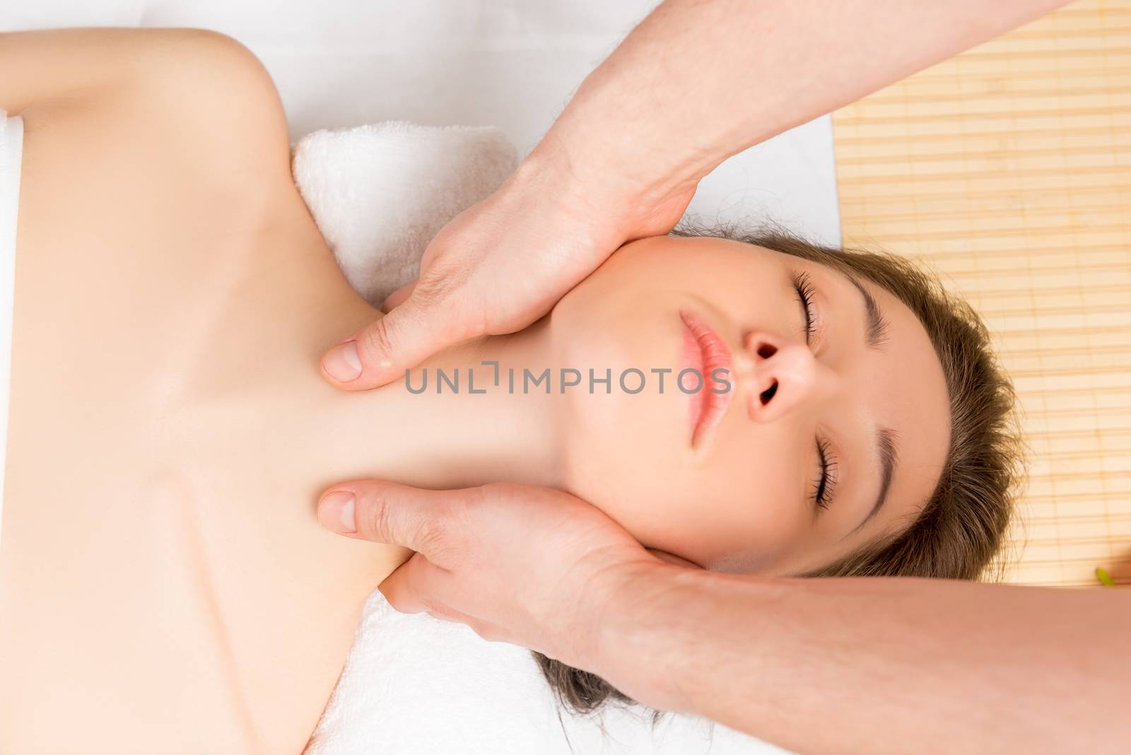 male hands on a female professional masseur neck and shoulders close-up