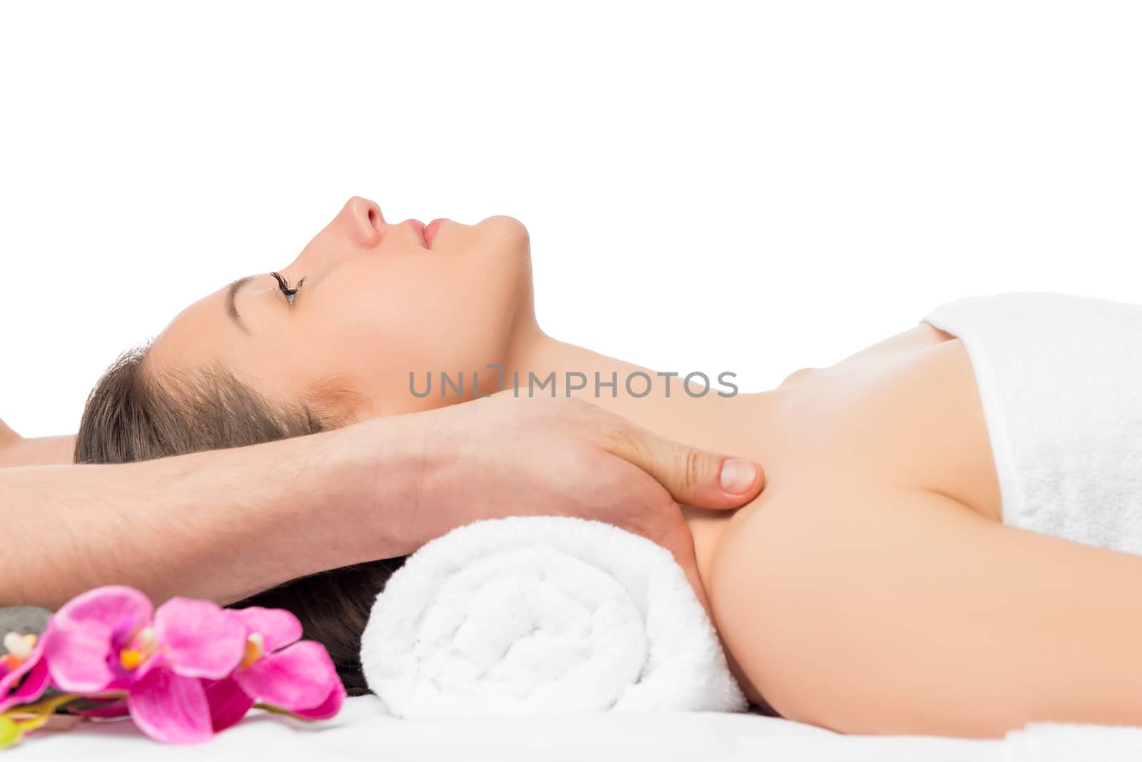 massage the shoulders of a young beautiful woman in spa salon