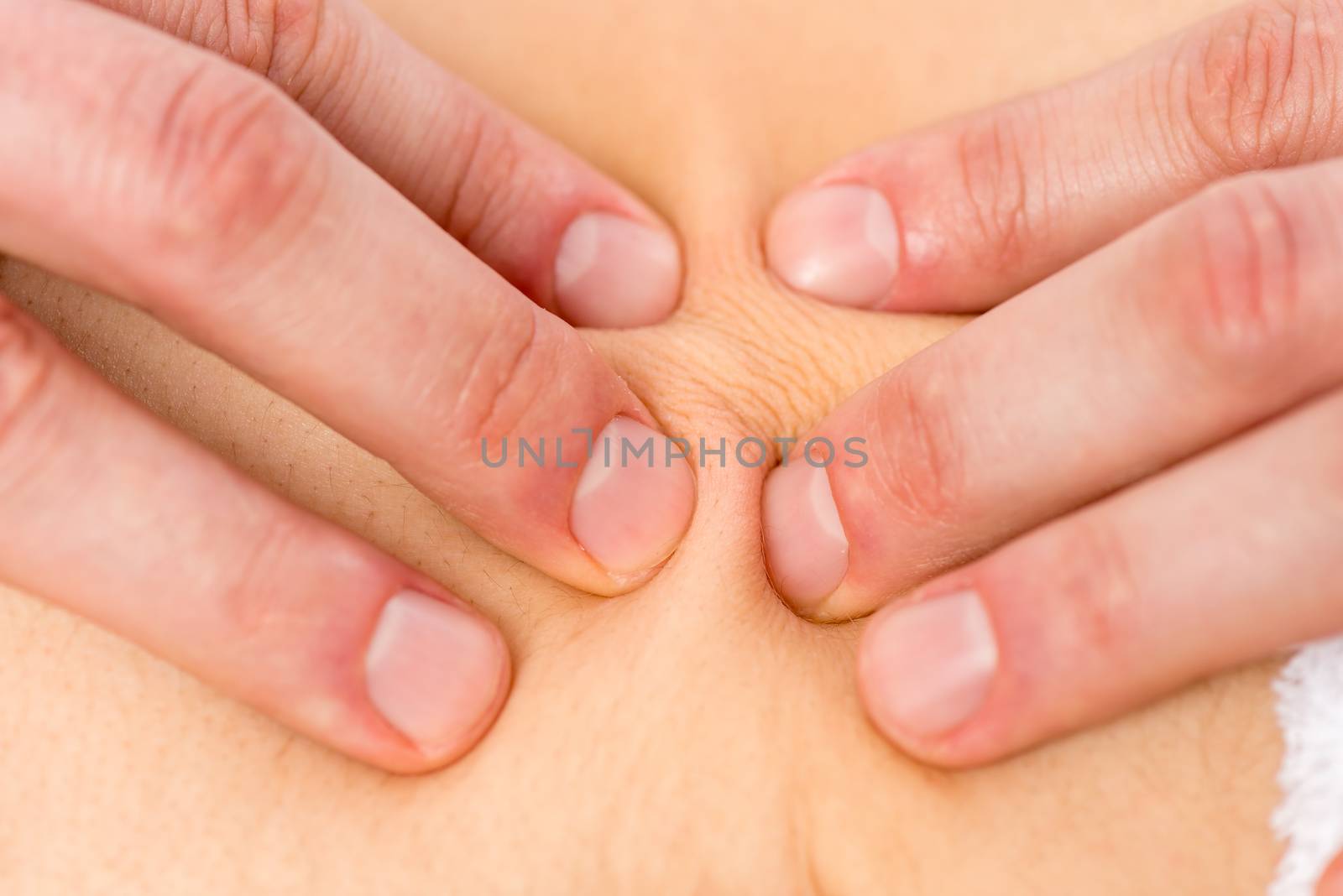 fingers masseur on the patient's skin close up