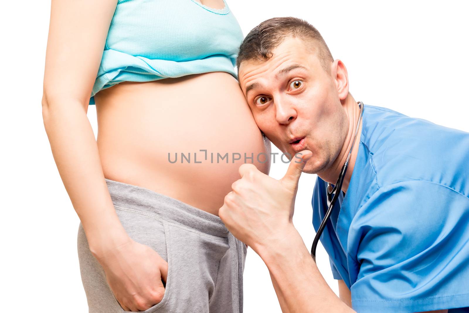 happy father and the doctor listening the baby in wife's stomach
