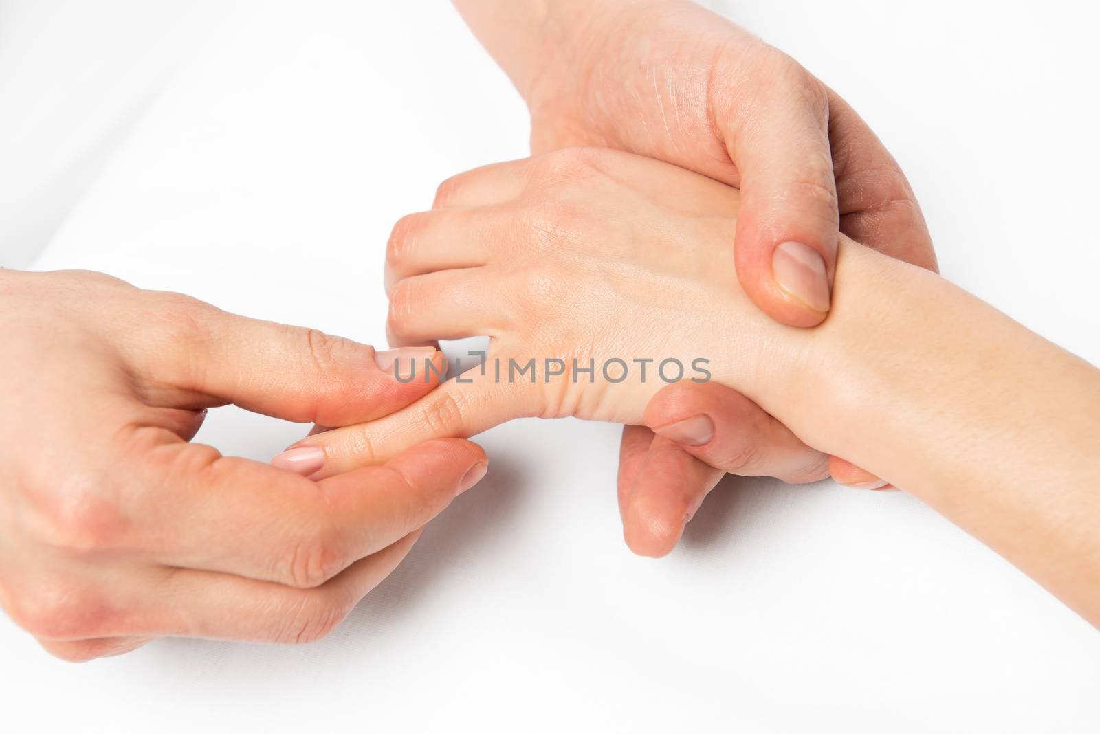 hand massage, the masseur is working on every finger, close up photo
