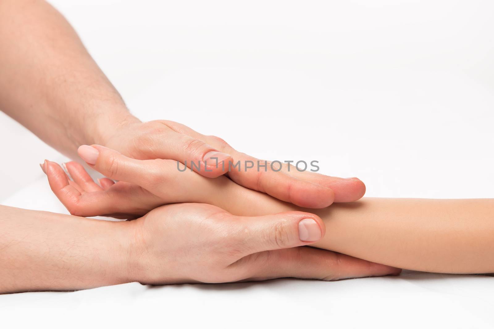 stroking massage of hands close up on a white background