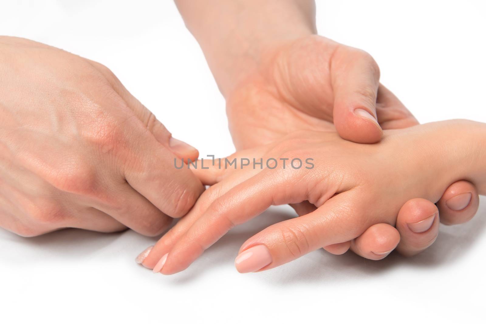 physiotherapist masseur kneads the patient's fingers