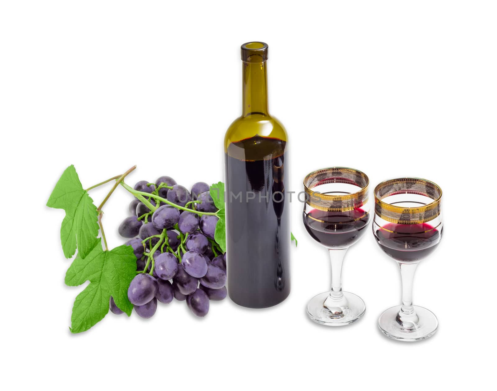 Two wine glasses with red wine, bottle of a wine and cluster of a blue grape with leaves on a light background
