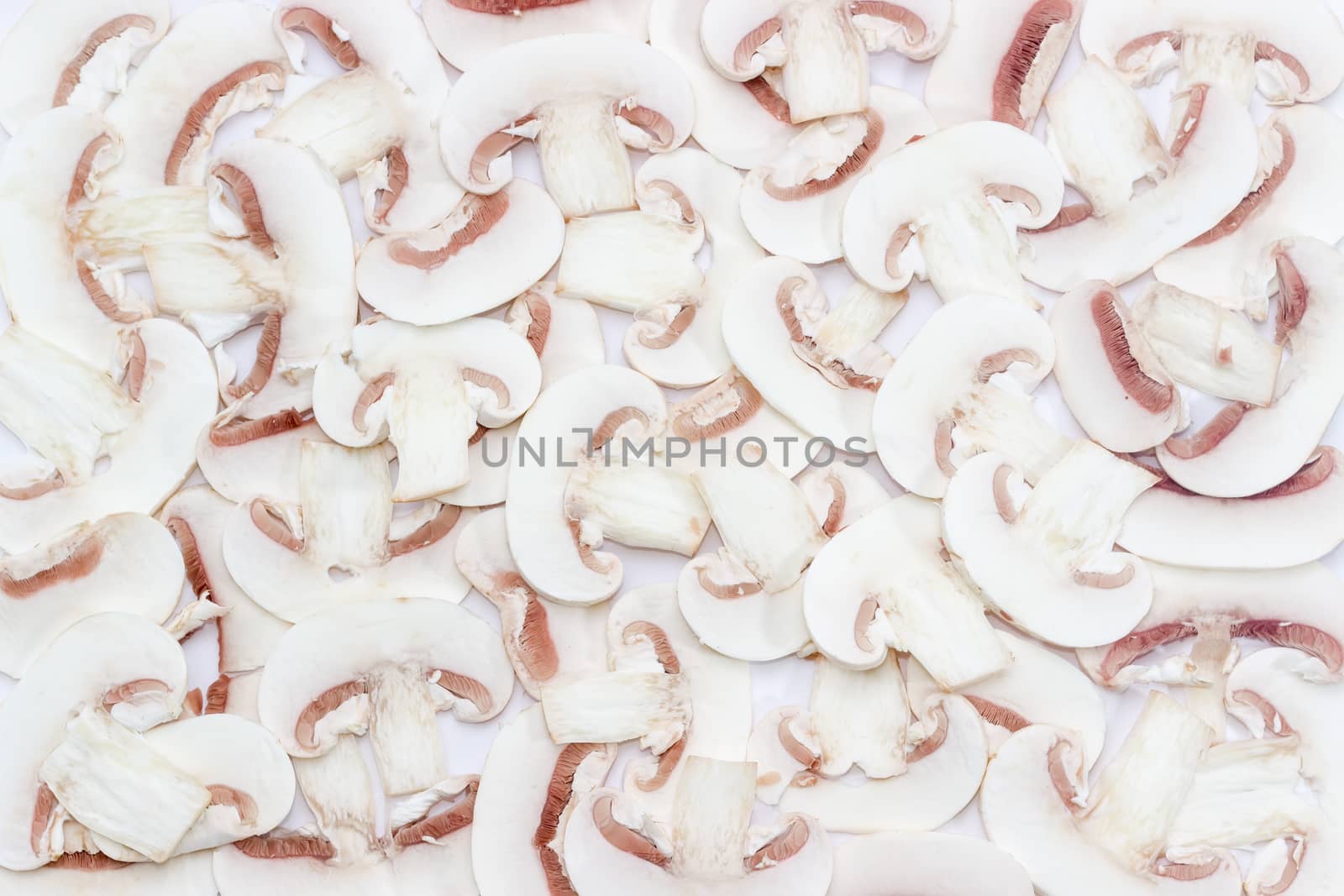 Background of chopped fresh uncooked button mushrooms into thin slices 
