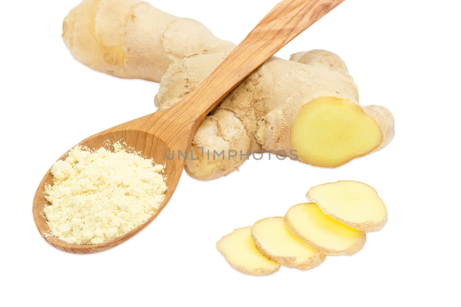 Ginger powder in a wooden spoon and a few slices of a fresh ginger against the backdrop of ginger root on a light background
