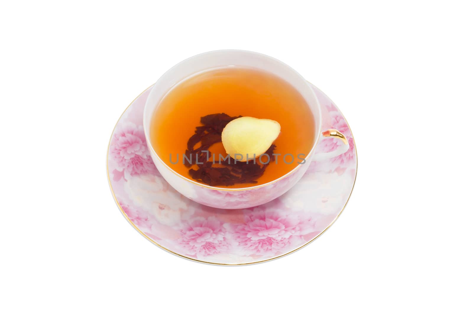 Cup of ginger tea with slice of a fresh ginger on pink saucer on a light background
