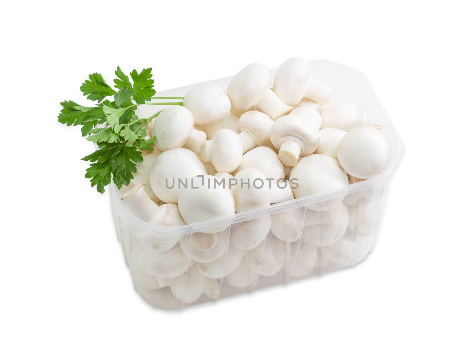 Fresh uncooked button mushrooms in a transparent plastic tray and a sprig of parsley on a light background 
