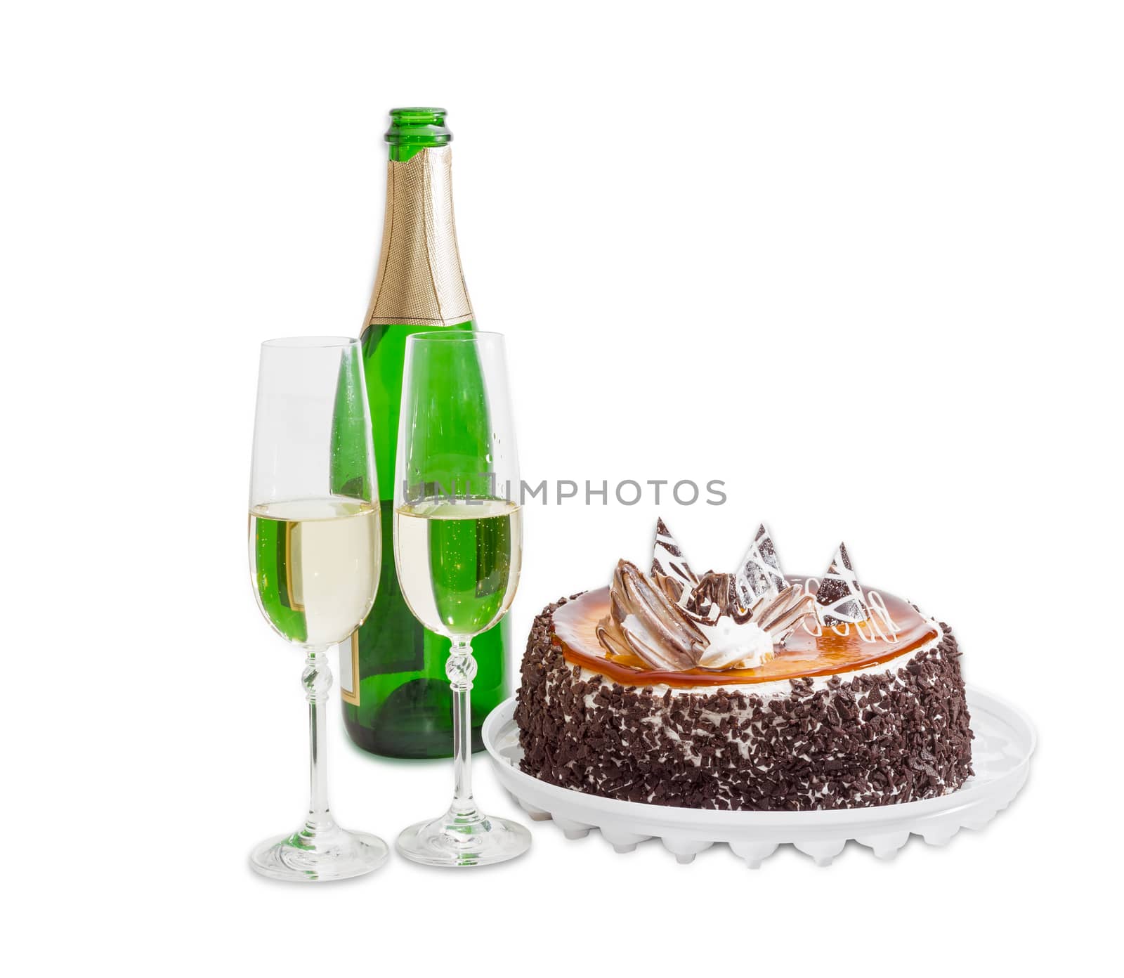 Two wine glasses with sparkling wine, a bottle of wine, sponge cake, covered with jelly and decorated with chocolate on a light background
