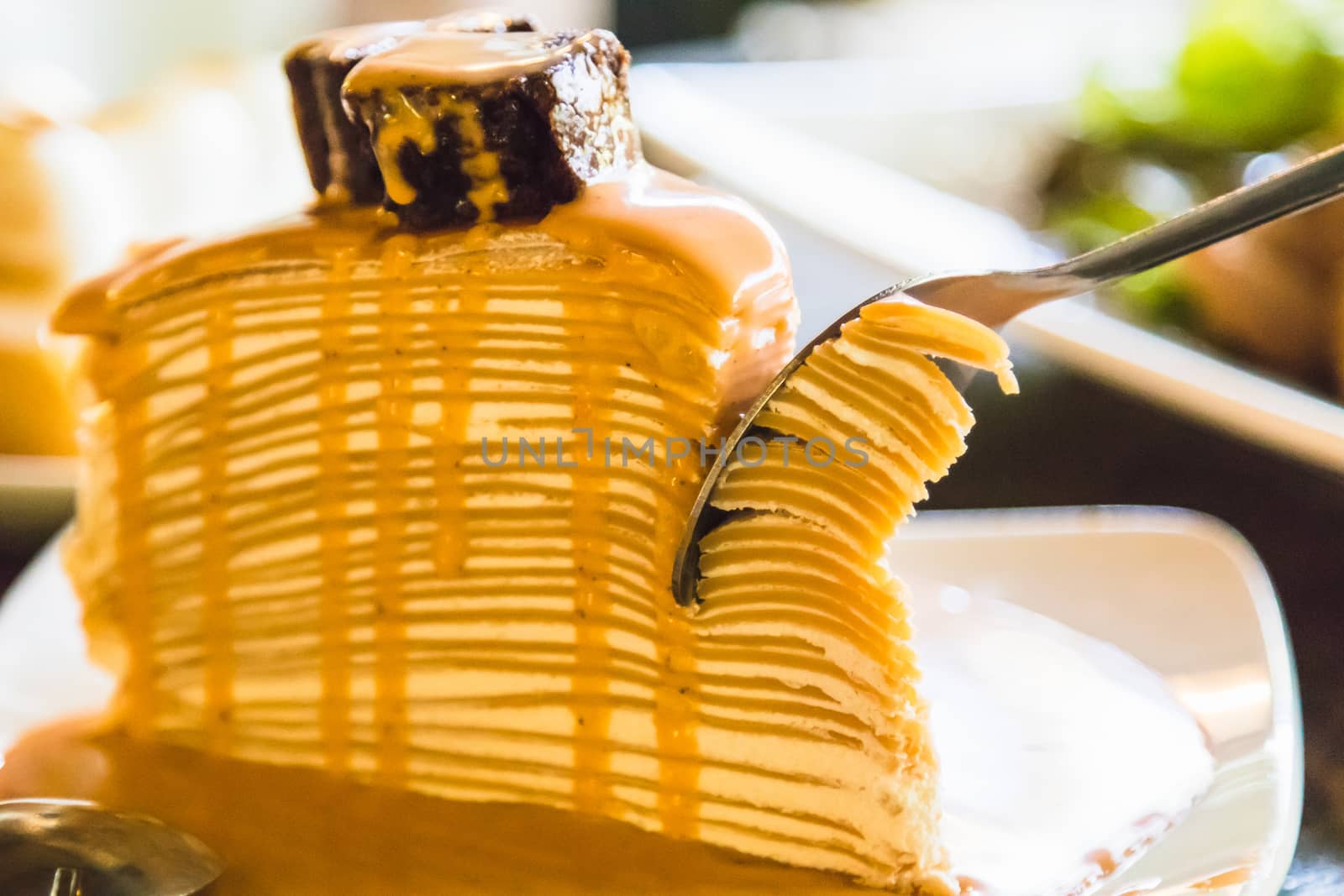 crepe cake with milk tea sauce on white dish