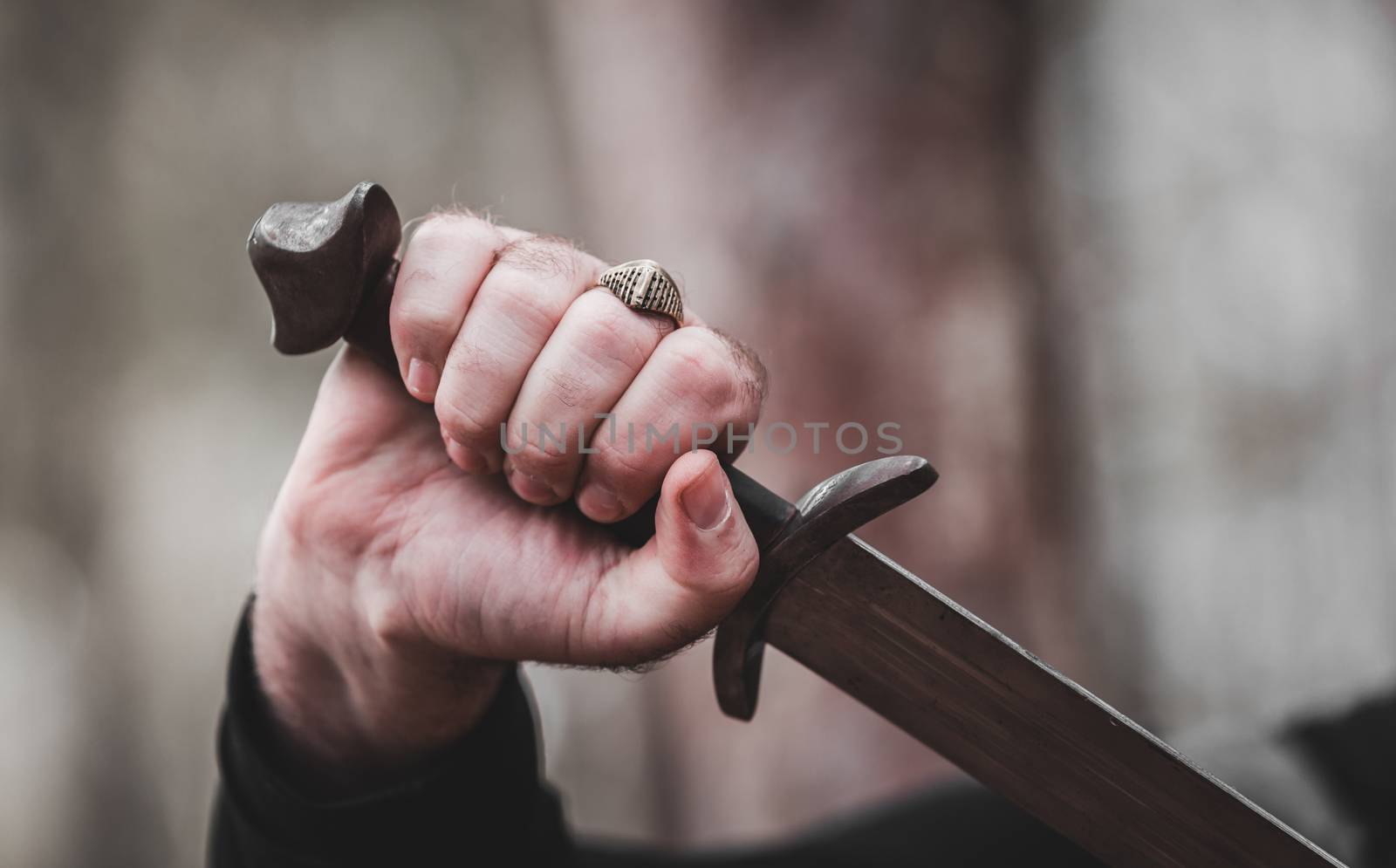 antique sword in the man's hand close-up