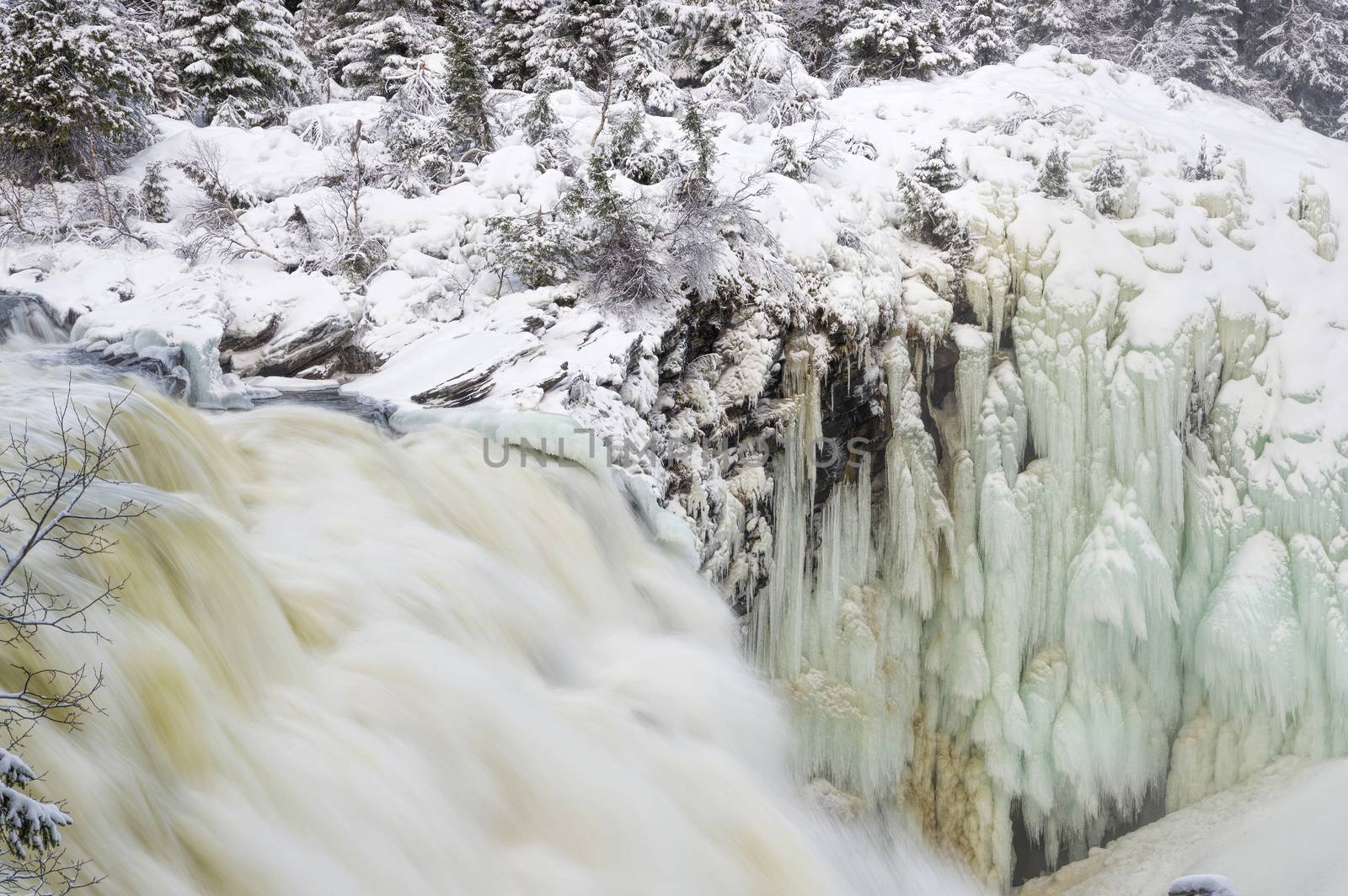 Tannoforsen waterfall in Sweden in winter by vizland