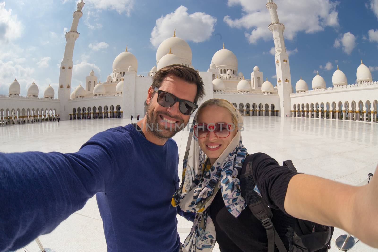Couple taking selfie in Sheikh Zayed Grand Mosque, Abu Dhabi, United Arab Emirates. by kasto