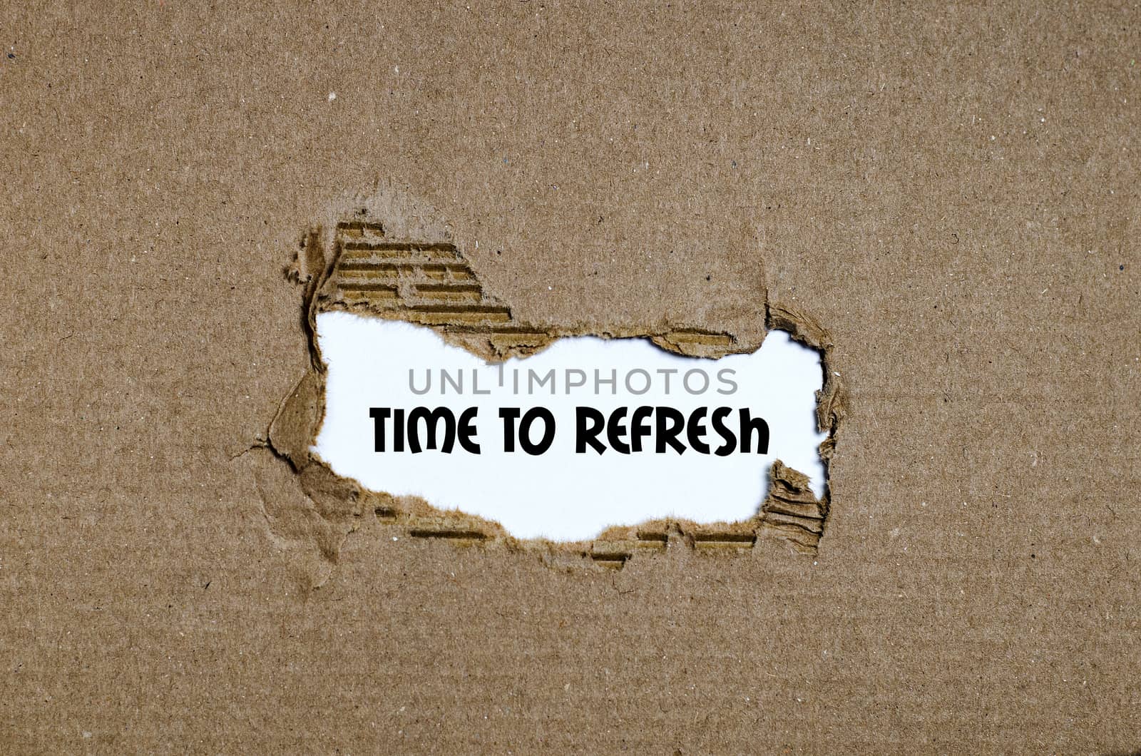 The word time to refresh appearing behind torn paper