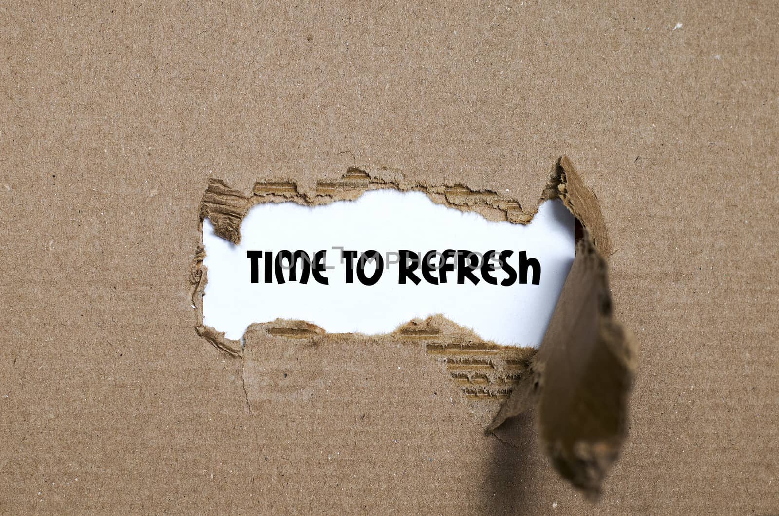 The word time to refresh appearing behind torn paper