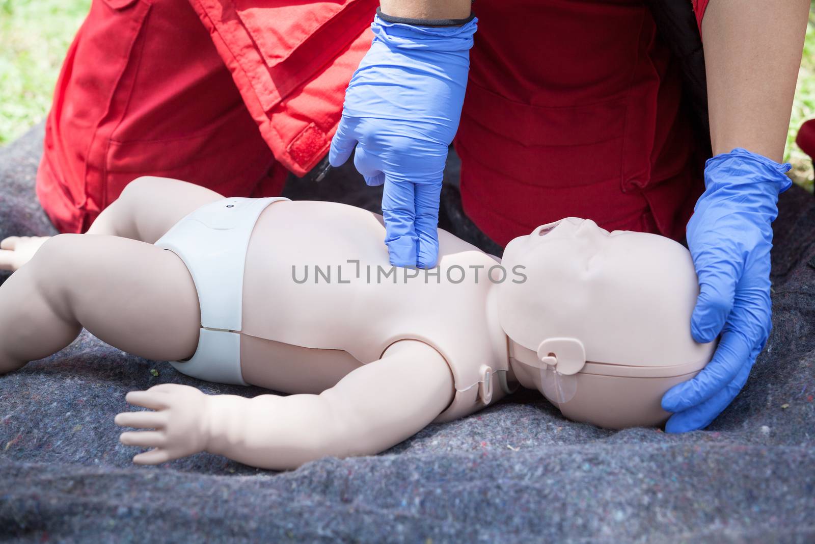 Baby CPR dummy first aid training. Heart massage. by wellphoto