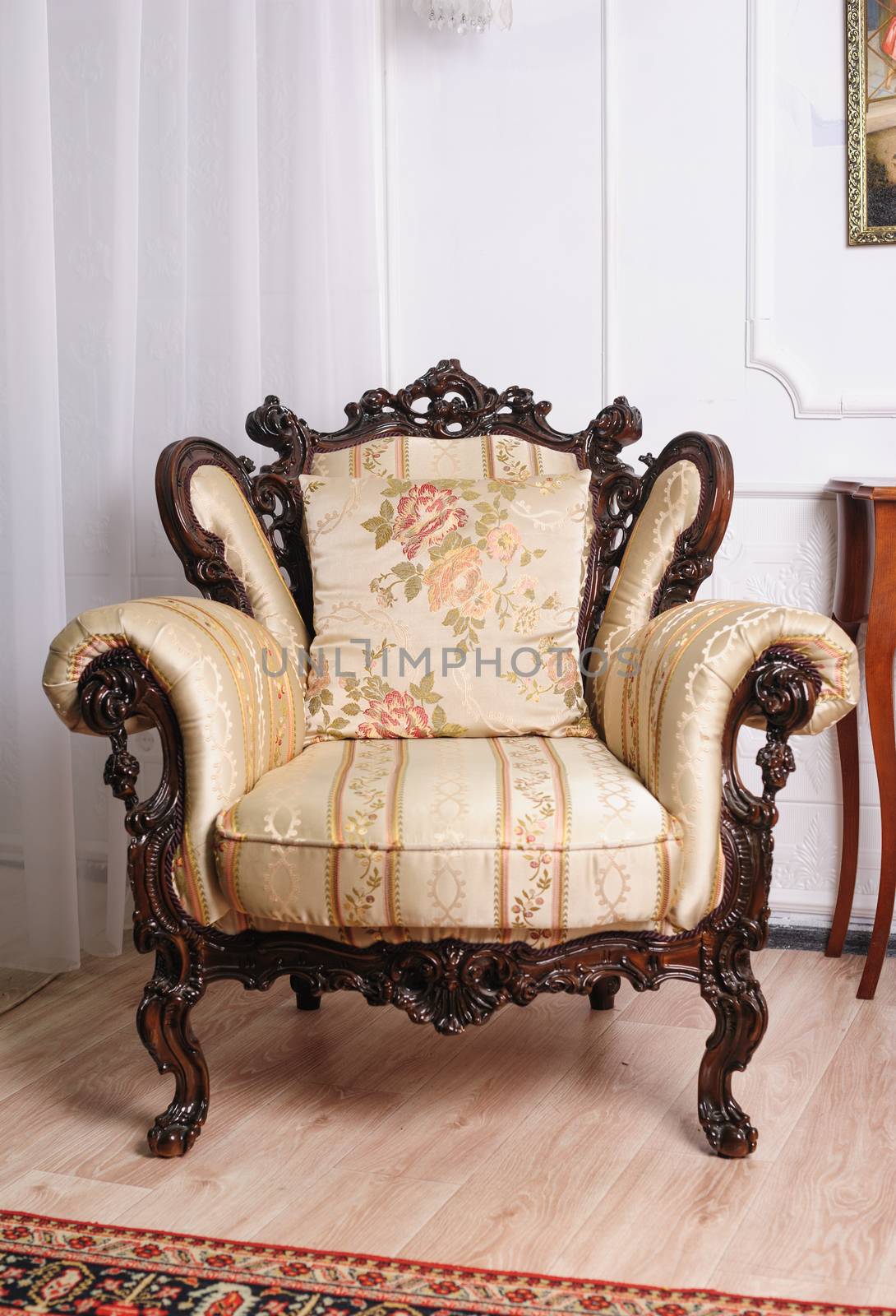 Luxury wooden antique chair in the room.