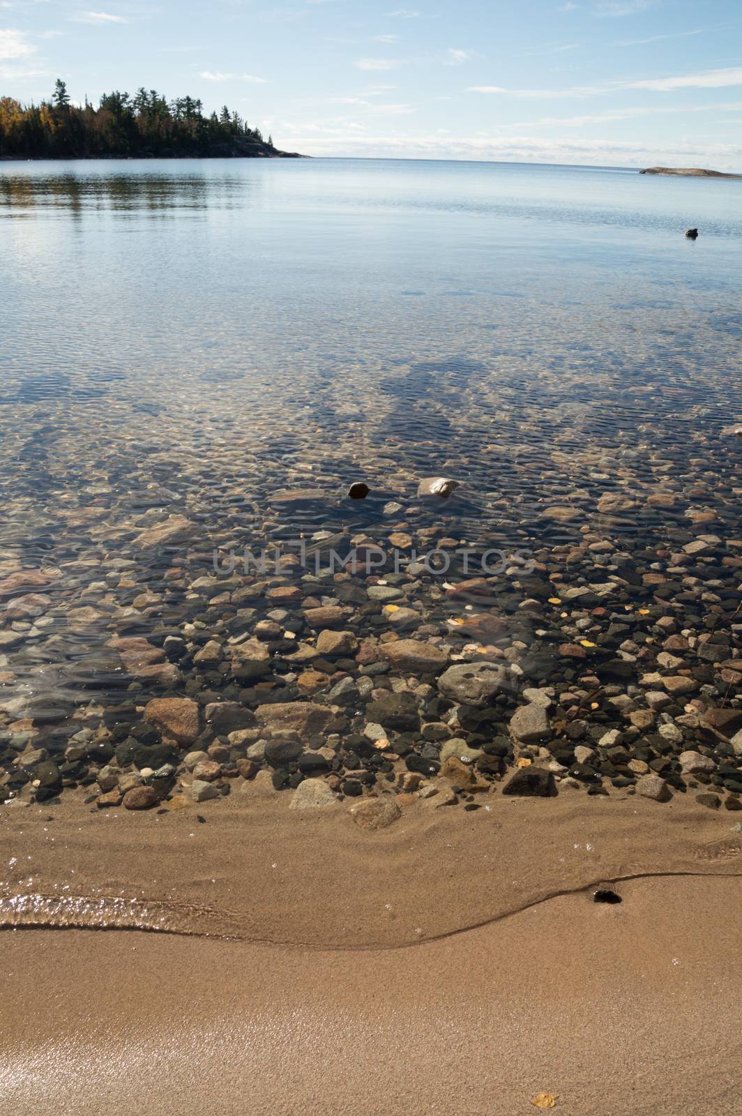 Crystal clear Lake Superior Beach with sand and rocks by Sublimage