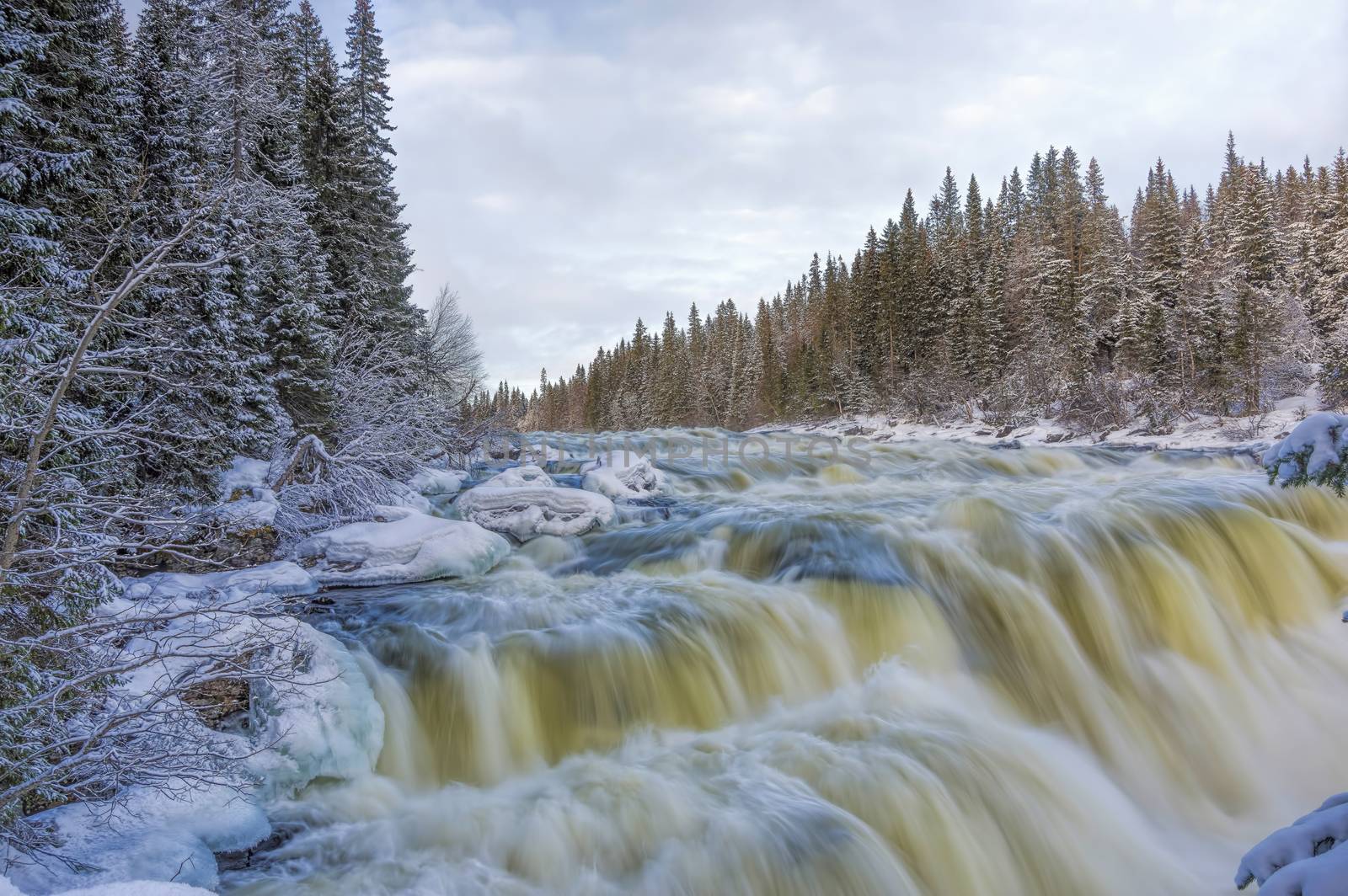 Tannoforsen waterfall in Sweden, does not freeze in the winter the water falls from a height of between stones