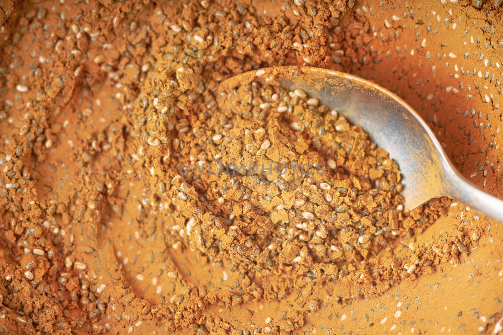 Cocoa powder and chia seeds mix with spoon background close-up
