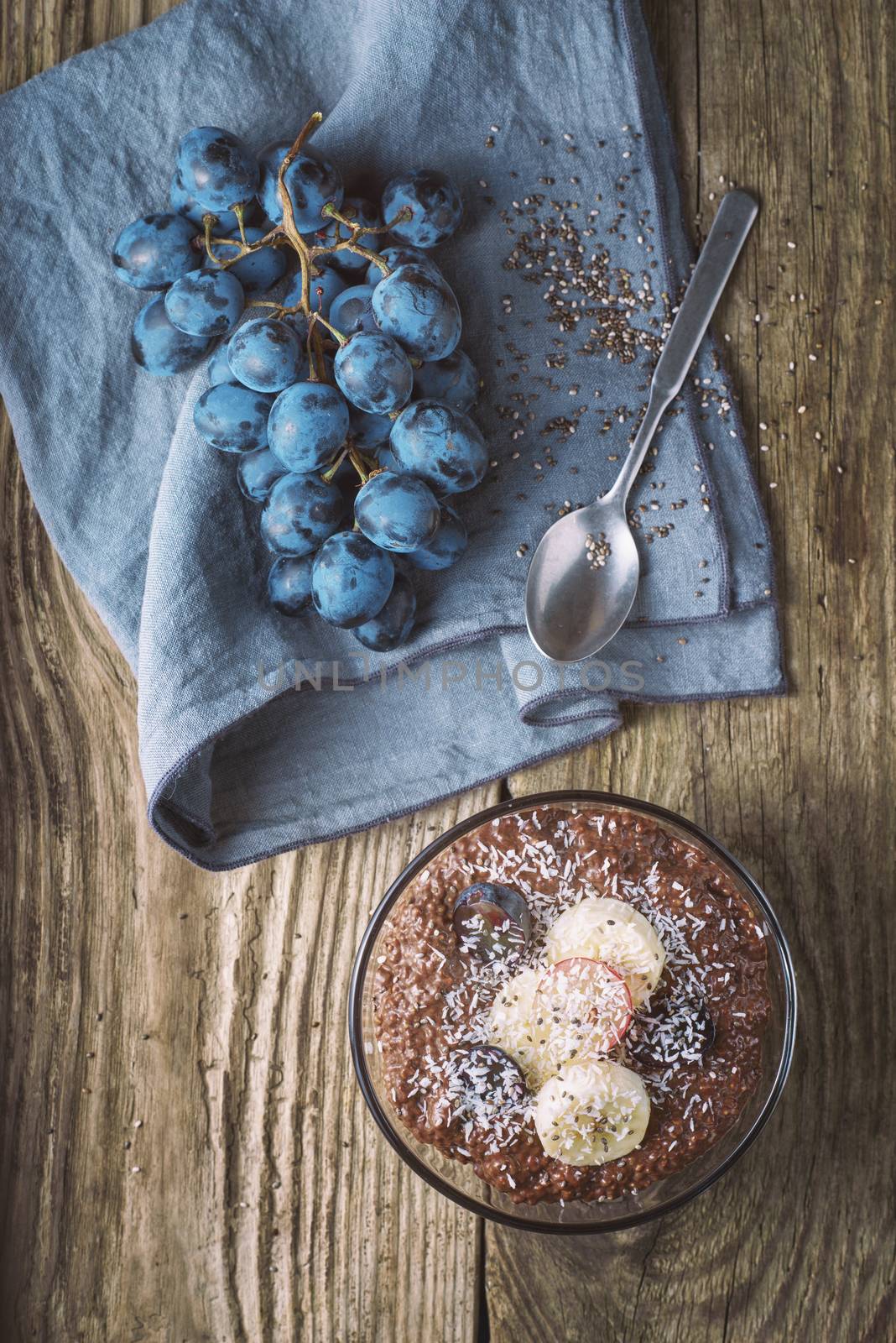 Chocolate chia pudding with fruit in the glass bowl top view by Deniskarpenkov
