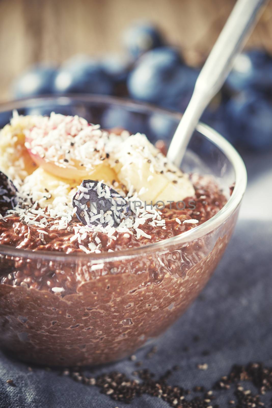 Chocolate chia pudding with fruits in the glass bowl