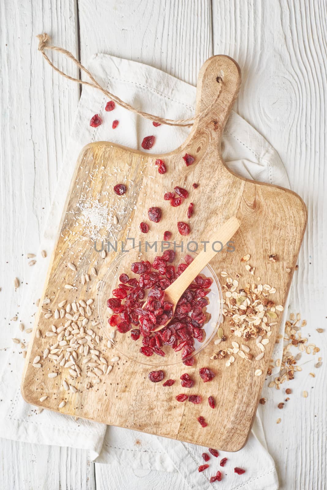 Dried cranberries  with cereal on the  white wooden table top view by Deniskarpenkov