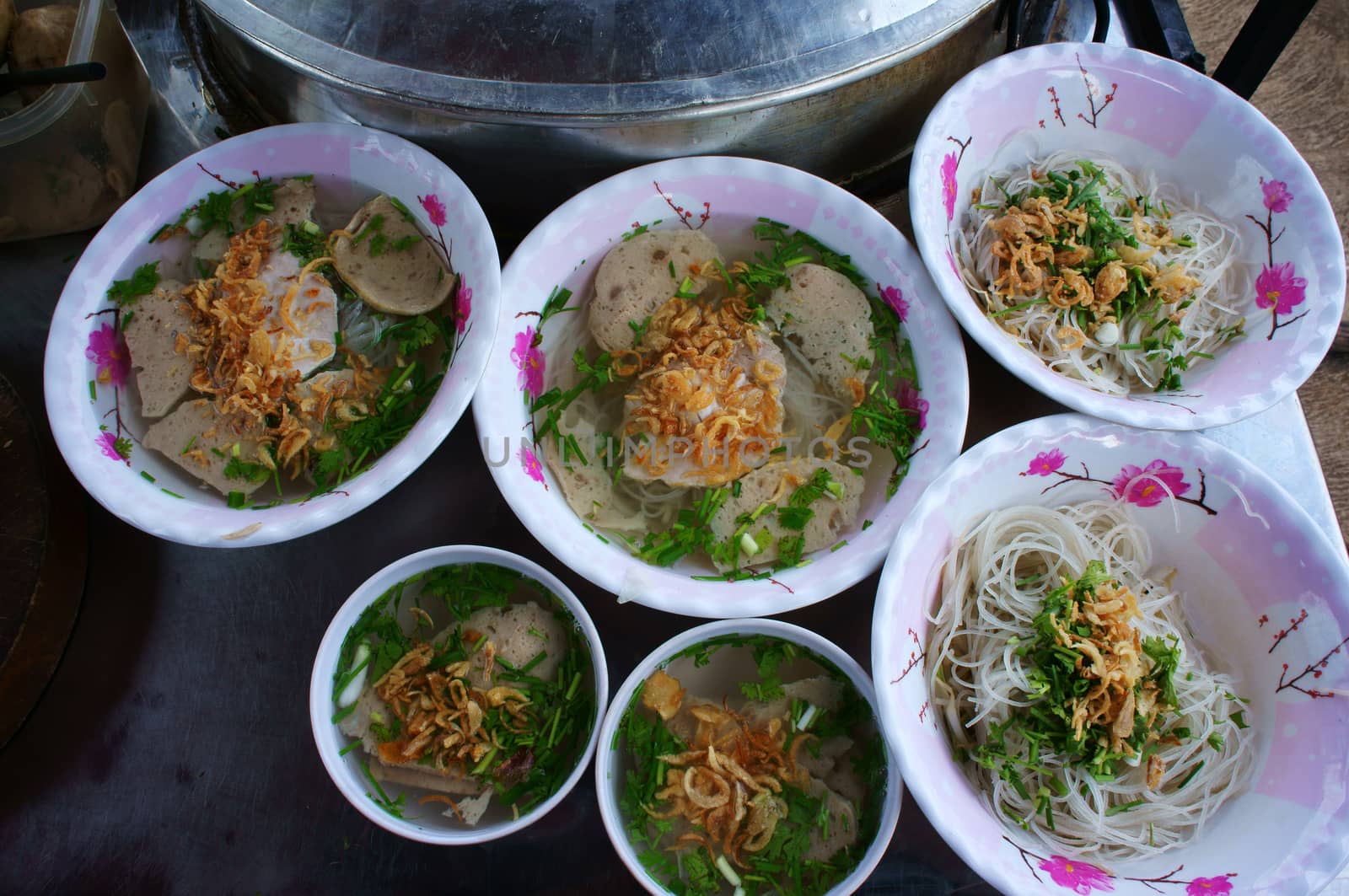 Vietnamese street food at Ho Chi Minh city, noodle soup, a popular streetfood from vendor, food in plastic bowl with beef ball and spice as dry onion