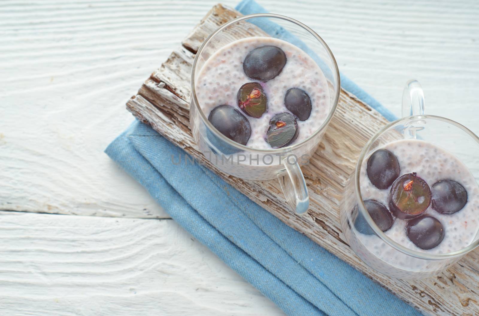 Chia pudding with grapes on the white wooden table by Deniskarpenkov