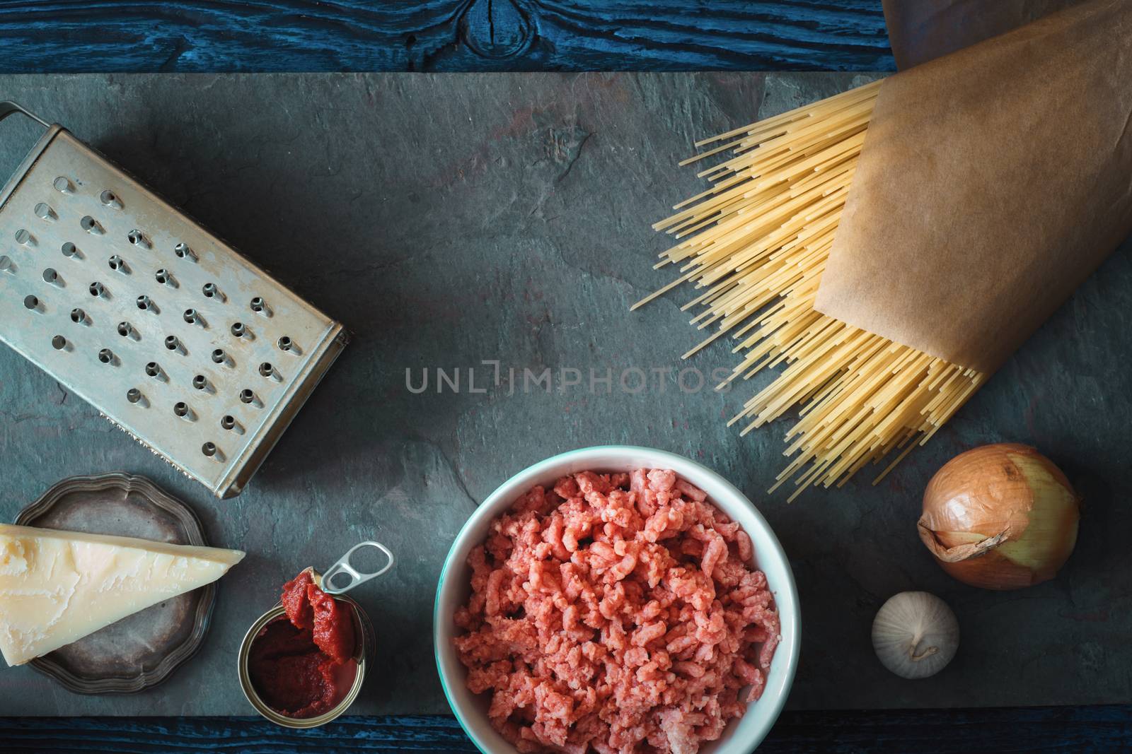 Ingredients for spaghetti with meatball on the stone background horizontal by Deniskarpenkov