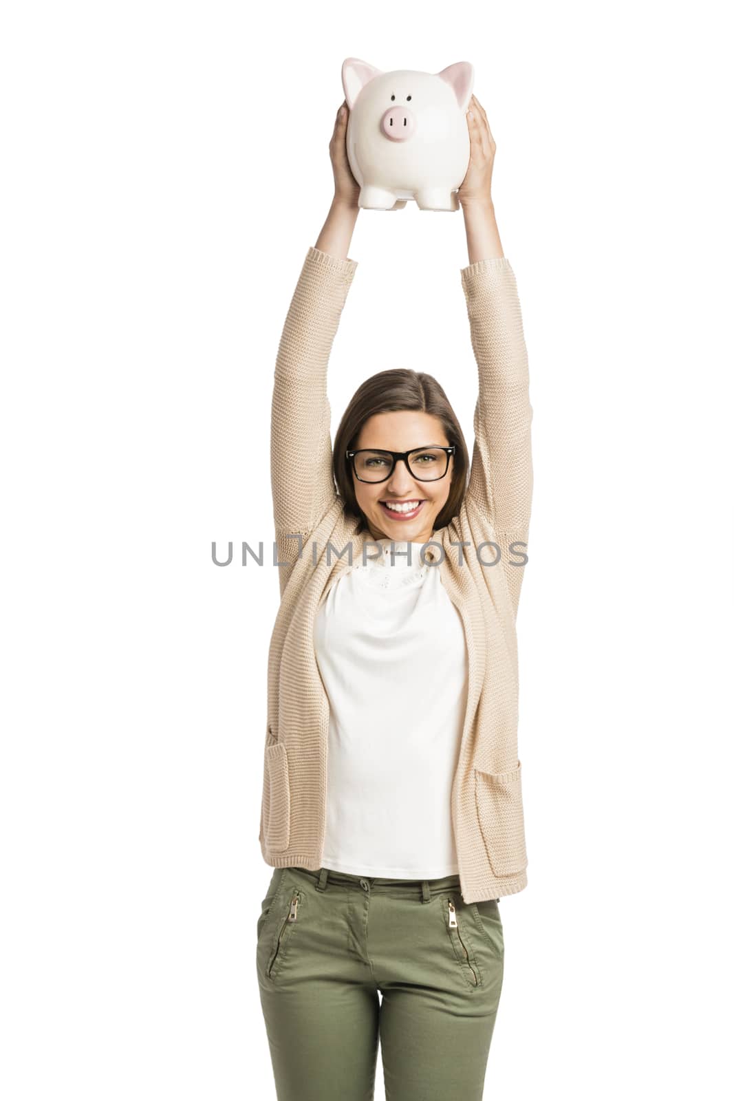 Beautiful and happy woman with arms high holding a piggy bank