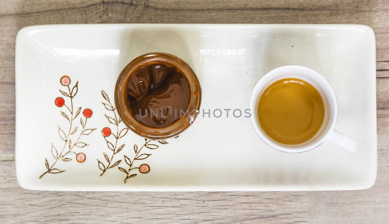 aerial view of a cip of coffee and a chocolate jar