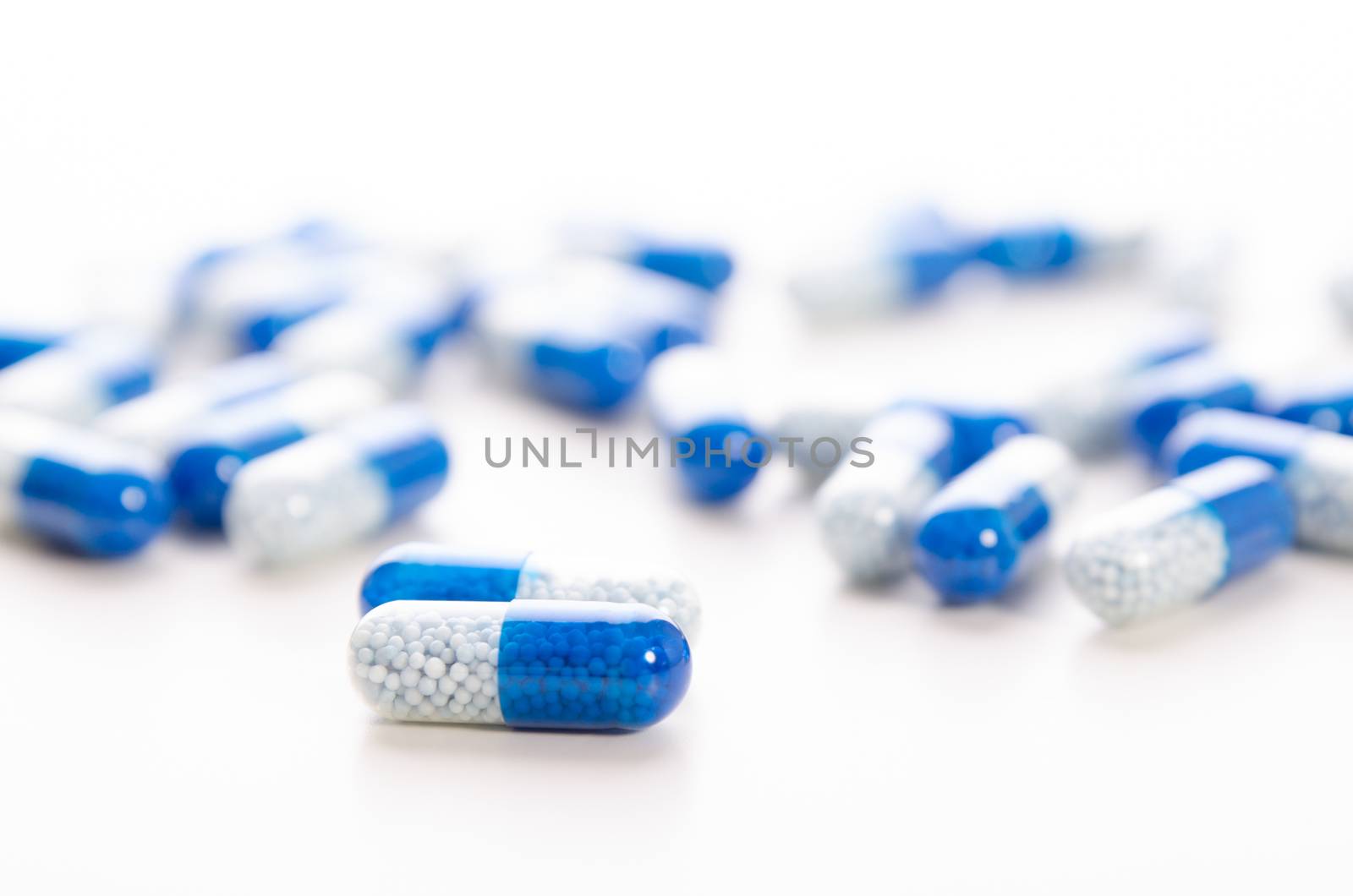 Pile of scattered capsules on a white background. capsules isolated white capsule pharmacy bottle pill drug concept