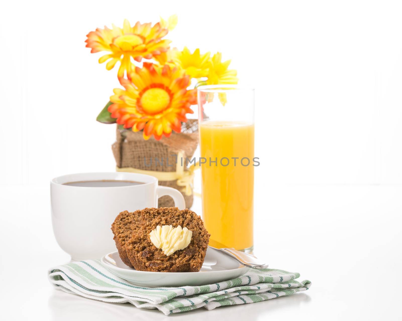 Fresh bran muffin served with coffee and orange juice.